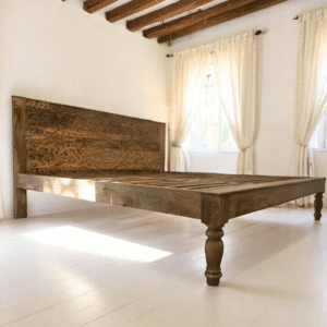 Hamd-carved solid wood queen bedframe with floral mandala design. Staged in a county style bedroom