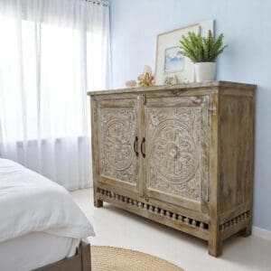 Hand-crafted solid mango wood sideboard in a natural sandblasted finish. Staged in a sunny bedroom