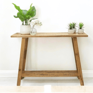 Rustic natural mango wood console table with decor accents staged in a home.