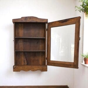 Hand-crafted Rustic small cupboard with 3 shelves and a glass door staged hanging on a wall. Spice cabinet, bathroom medicine cabinet/