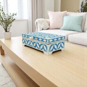 hand-crafted blue and white inlay keepsake box staged on a living room table.